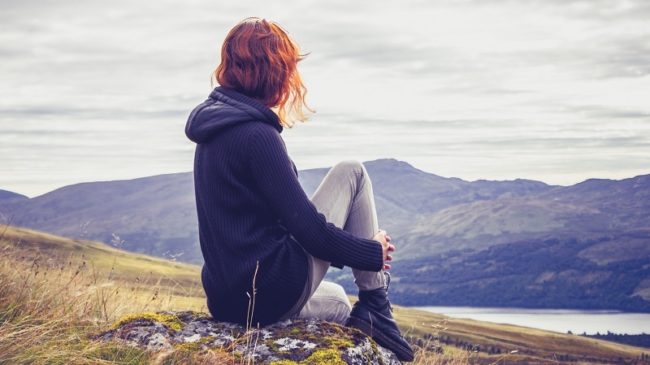 Woman relaxing on mountain top