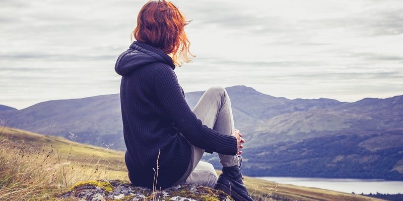 Woman relaxing on mountain top