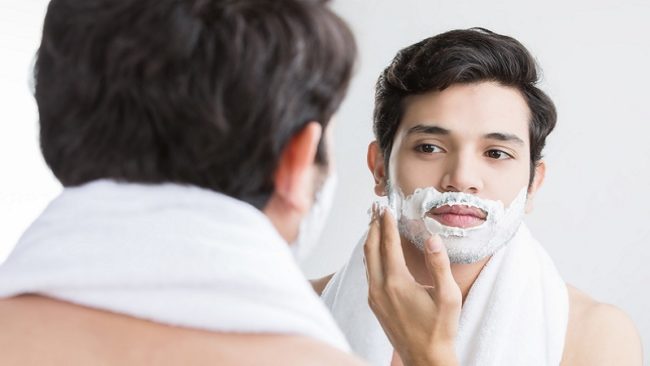 Man shaving in the bathroom.